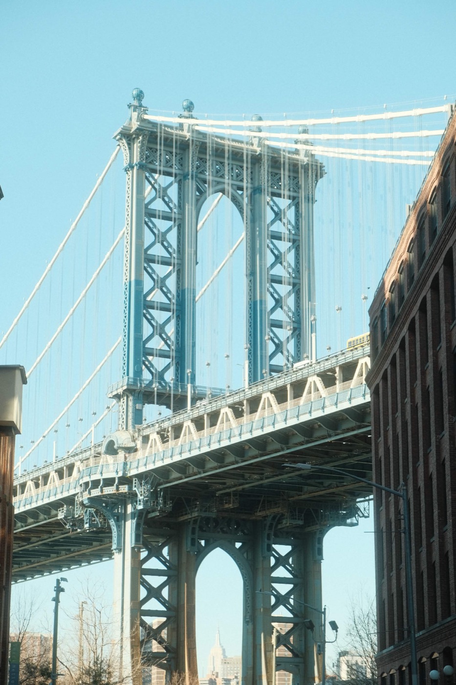 A suspension bridge tower against a blue sky